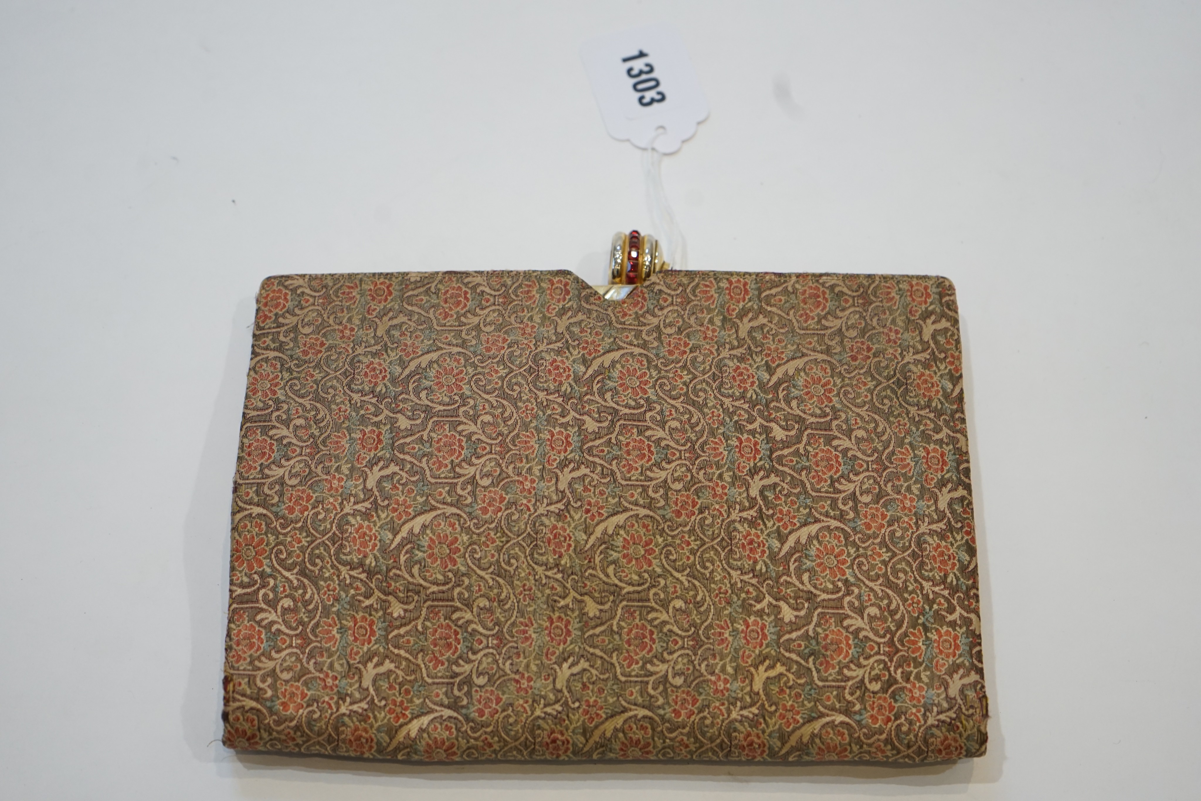 A vintage Christian Dior brocade clutch bag, with faux ruby set clasp and original mirror